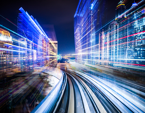 Digital composite of a train traveling through a futuristic city.